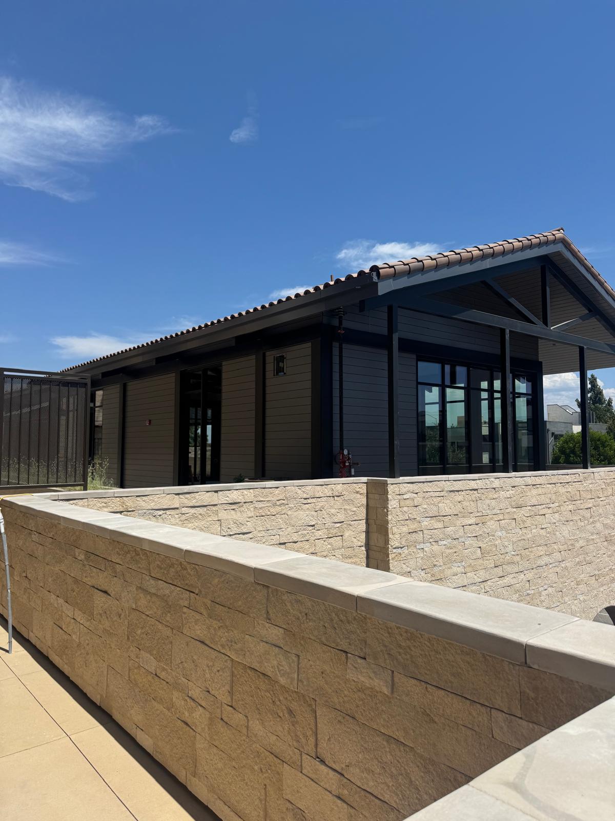 Dark charcoal aluminum siding on a building exterior showing a durable low-maintenance finish