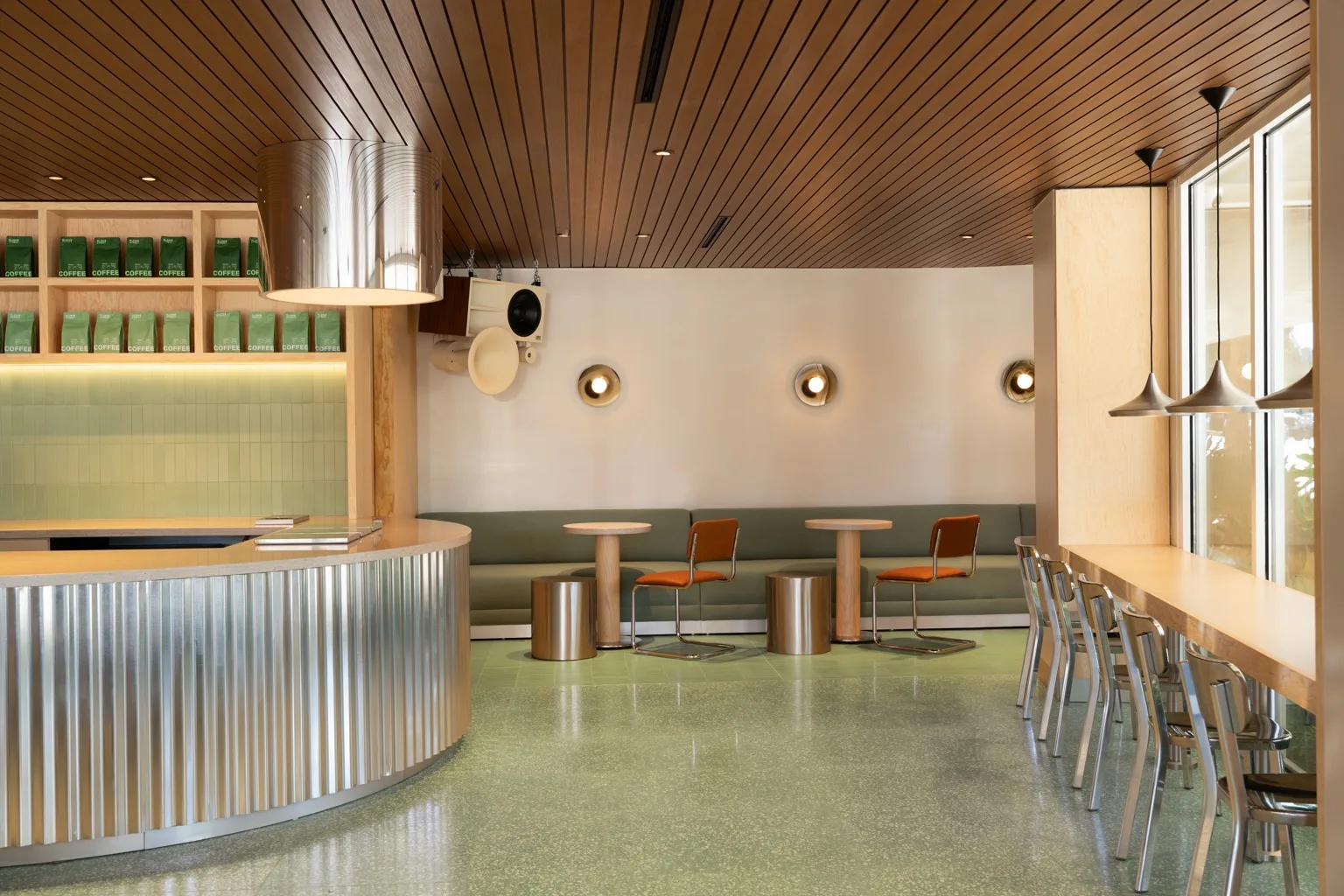 Wood-look aluminum ceiling profiles running from the counter to the window seating at Blank Street