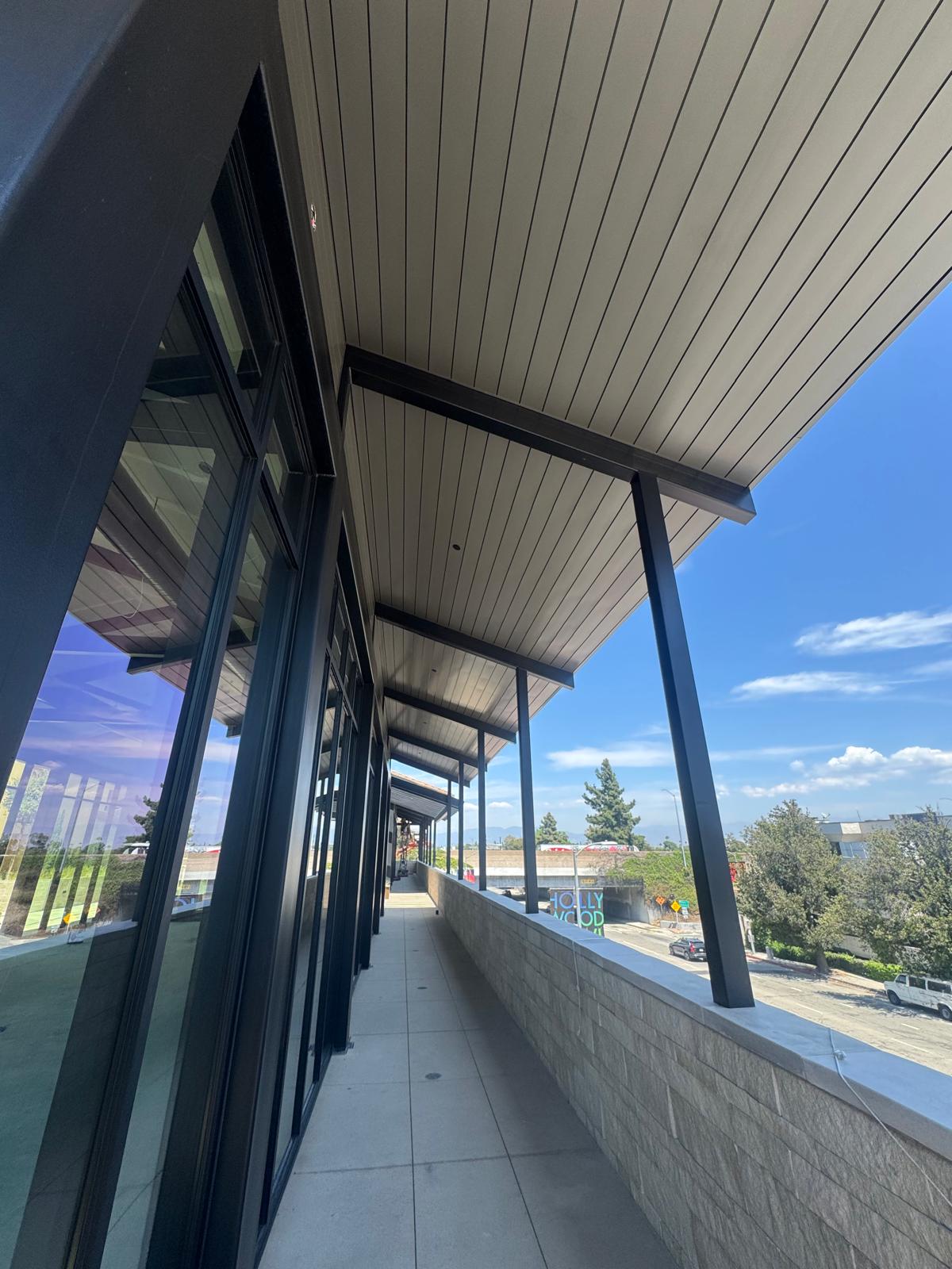 Wood-look aluminum soffit over a Los Angeles commercial walkway
