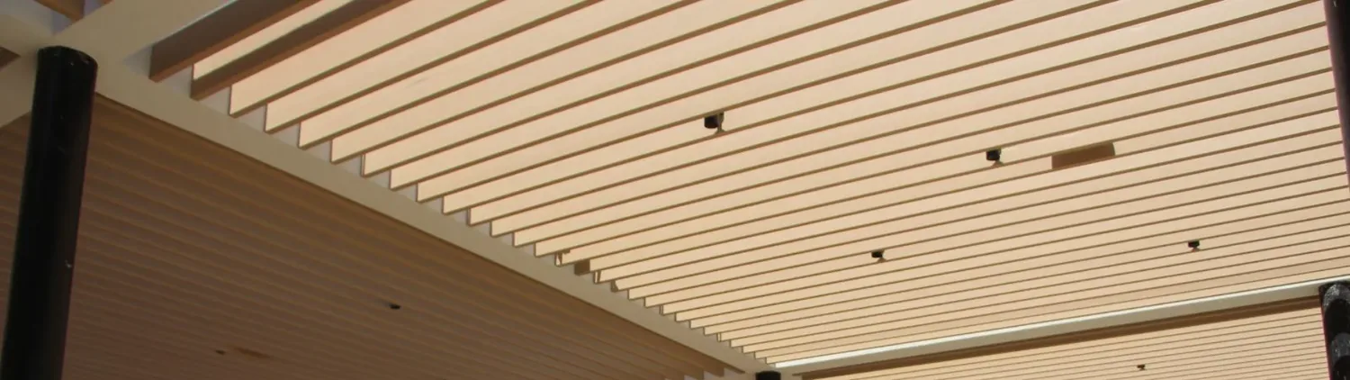 Close-up of wood-look aluminum trellis slats showing the grain finish and repeated rhythm