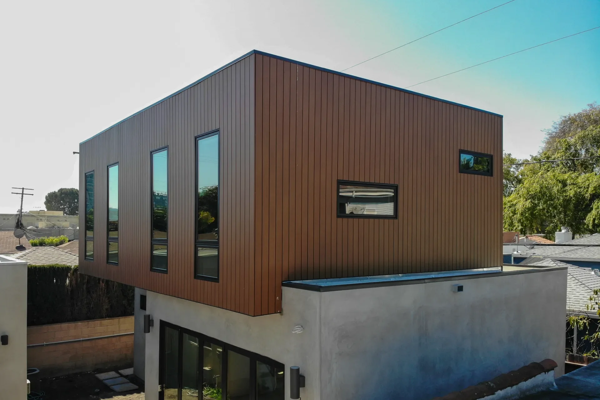 Walnut wood-look aluminum cladding on a modern two-story home